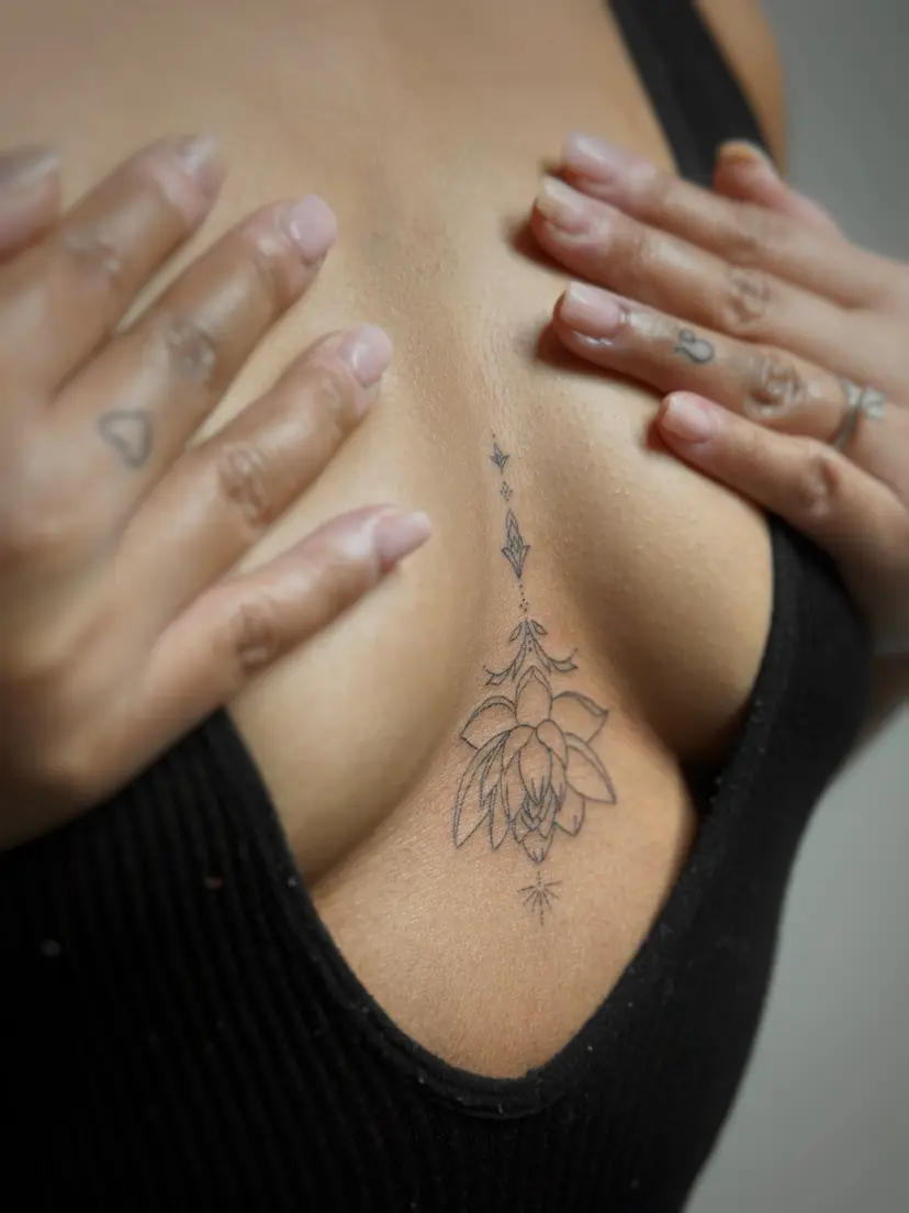 Ornamental lotus tattoo on the sternum