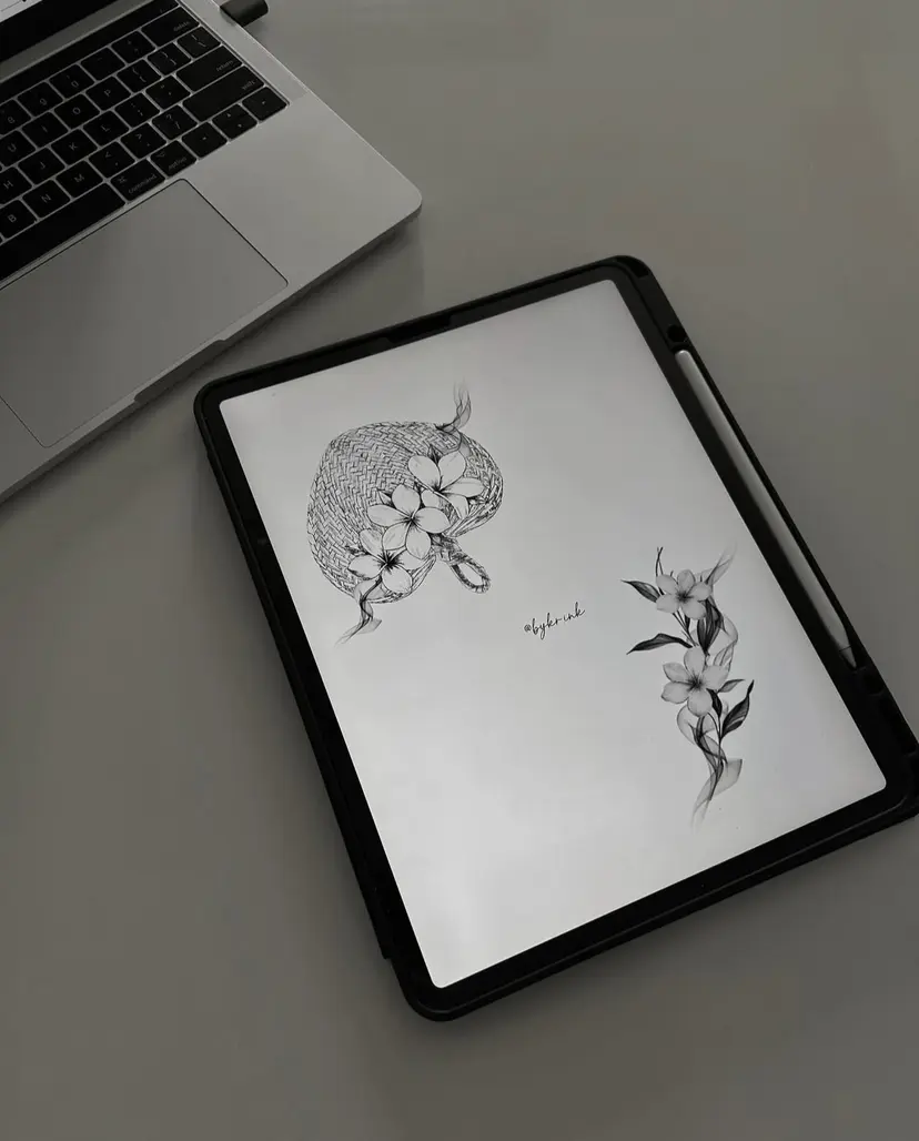 Two flash tattoo designs on a tablet: a dotwork ball with flowers, and a flower stem